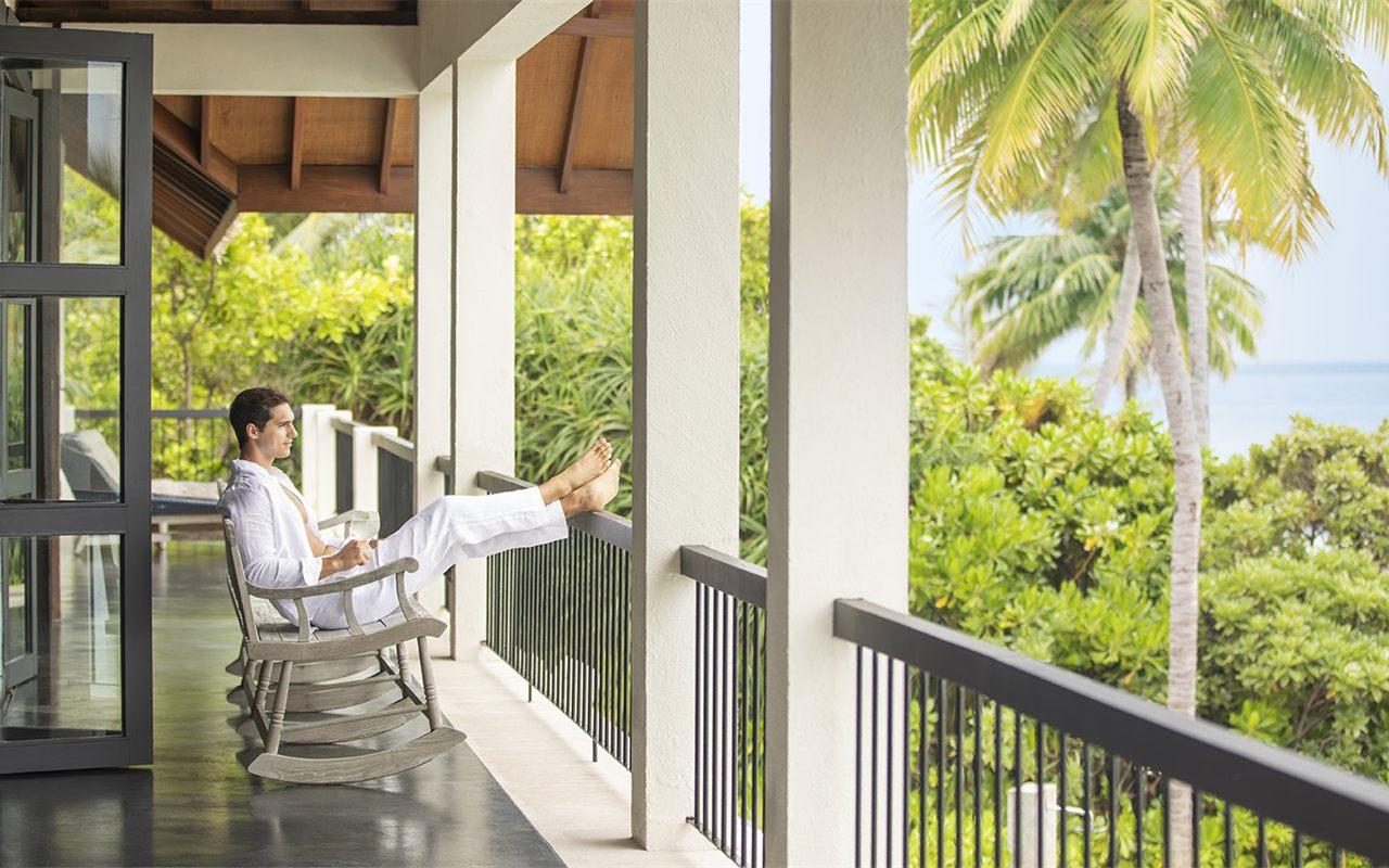 Veranda d'une villa de Four Seasons Voavah avec rocking-chair en teck face aux cocotiers