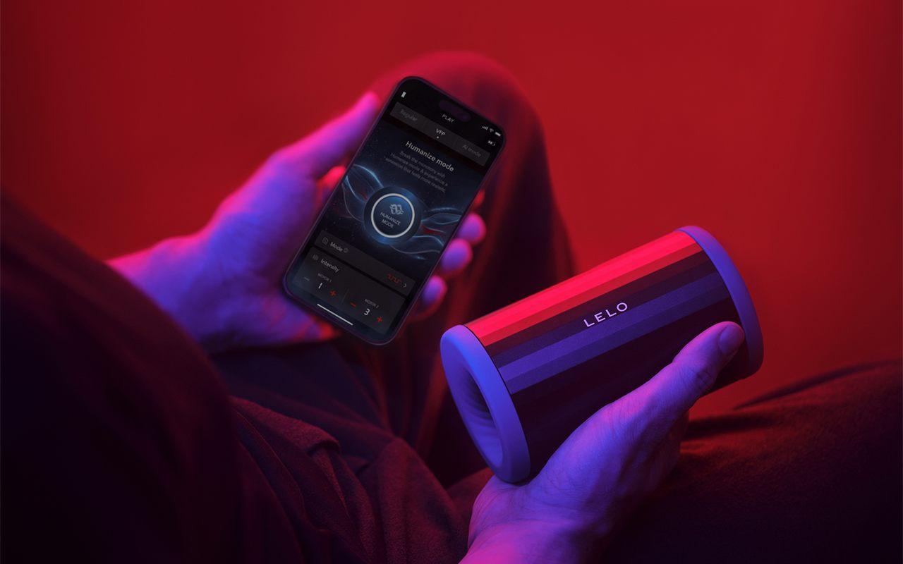 Une main tient le LELO F2S Double Sonic, l'autre l'application LELO sur iPhone