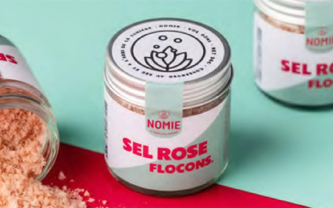 Pot de sel rose en flocons Nomie sur fond bleu et rouge