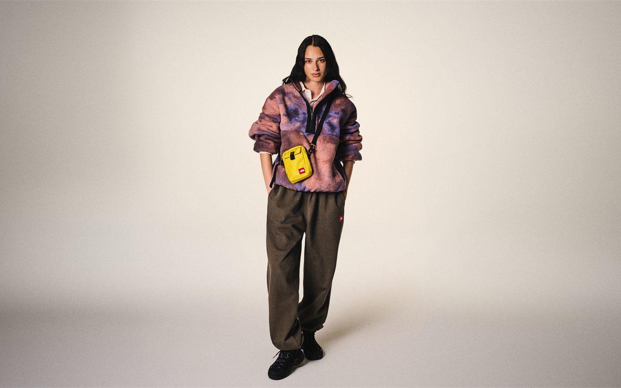La sacoche jaune Red Box FW26 portée en bandoulière sur la polaire imprimée