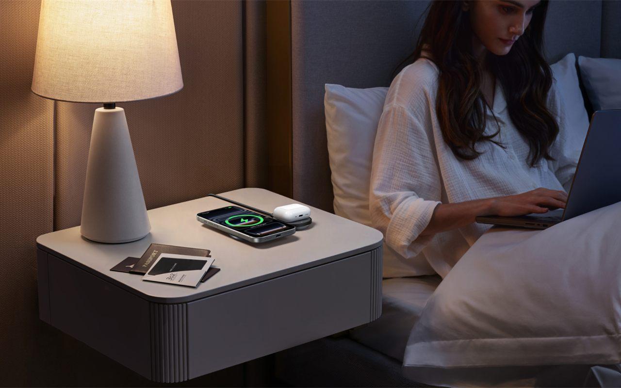 Chargeur pliable UGREEN MagFlow 2-en-1 déplié sur la table de nuit d'une chambre d'hôtel