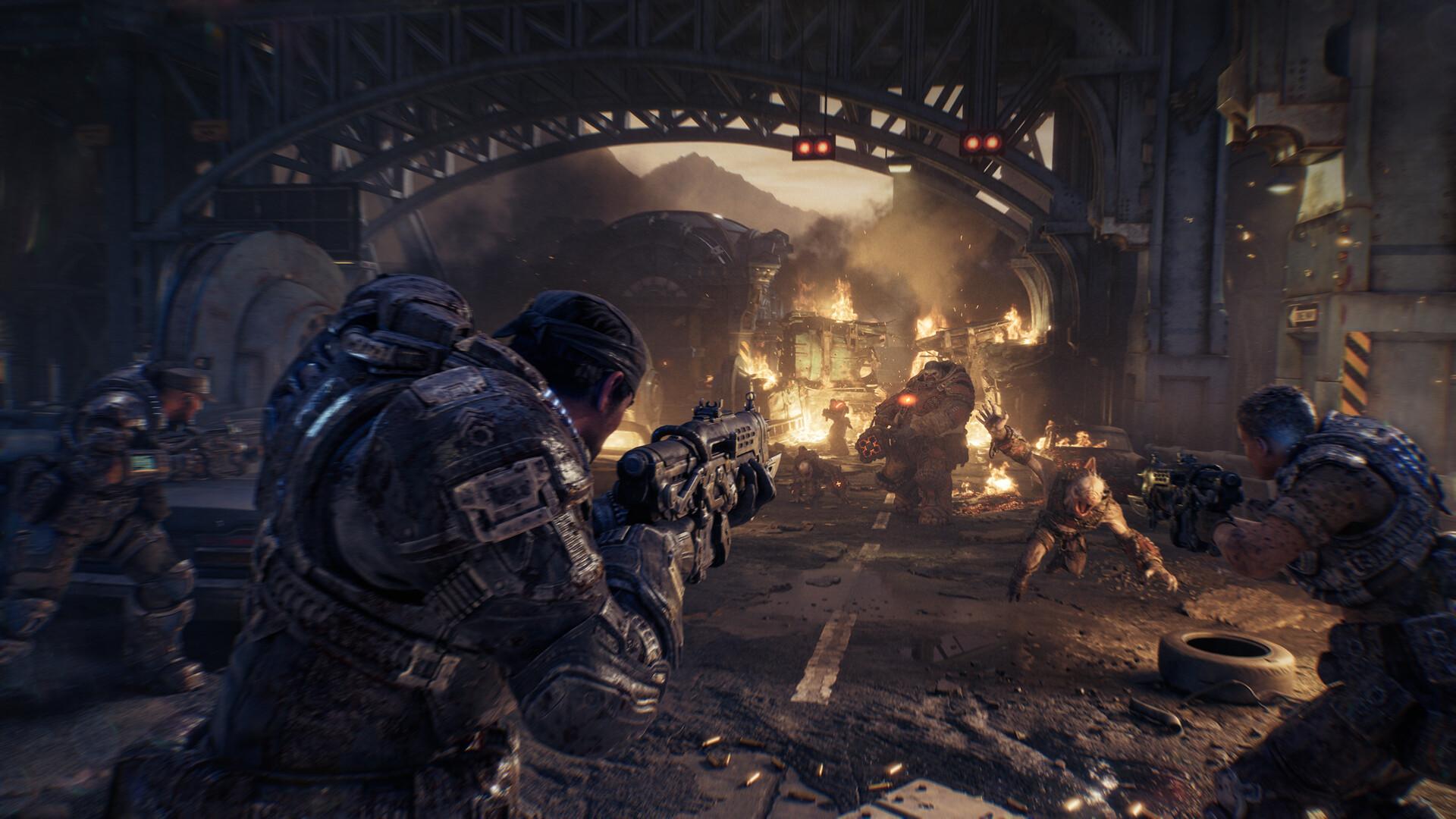 Gears of War: E-Day, Marcus Fenix et son escouade ouvrent le feu sur des Locustes sous un pont métallique en flammes