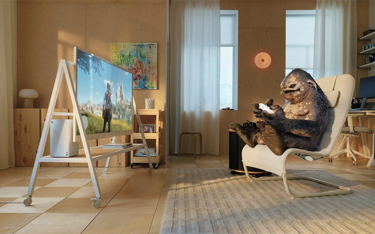 Le support TV à roulettes de la collection IKEA YXSTABY, console rangée derrière l'écran, devant un fauteuil gaming
