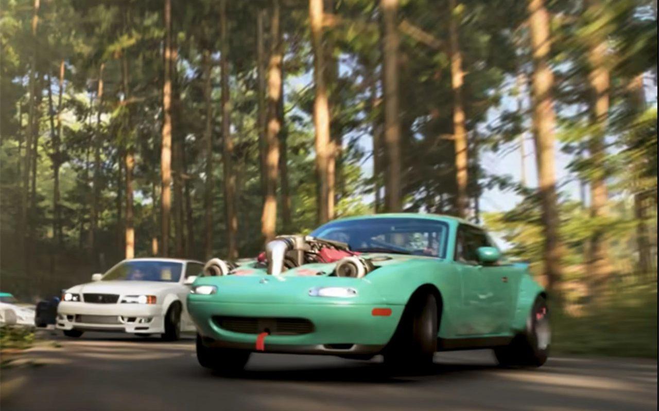 Mazda MX-5 verte en pleine glisse sur une route forestière