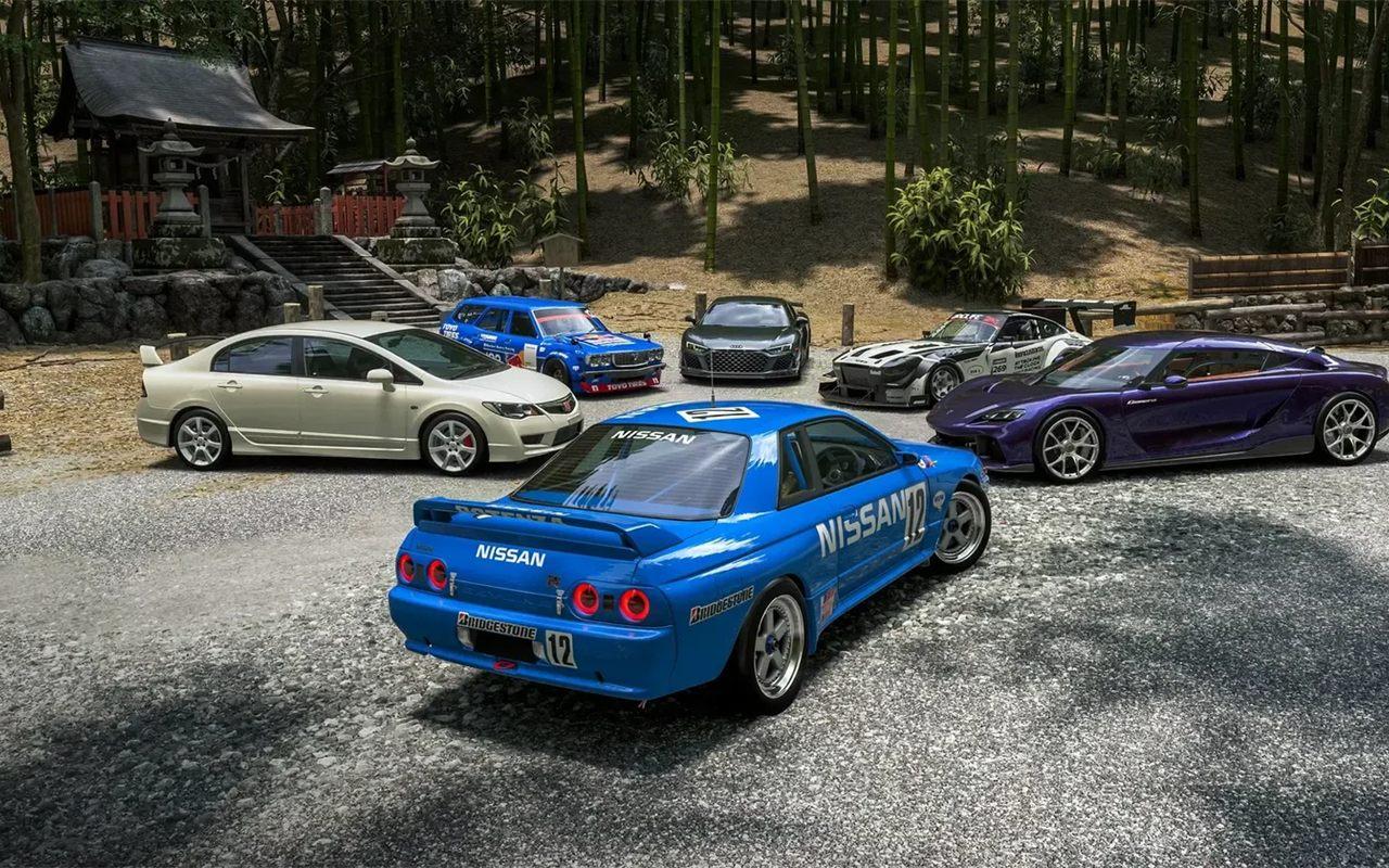 Nissan Skyline GT-R bleue et voitures japonaises garées devant un temple