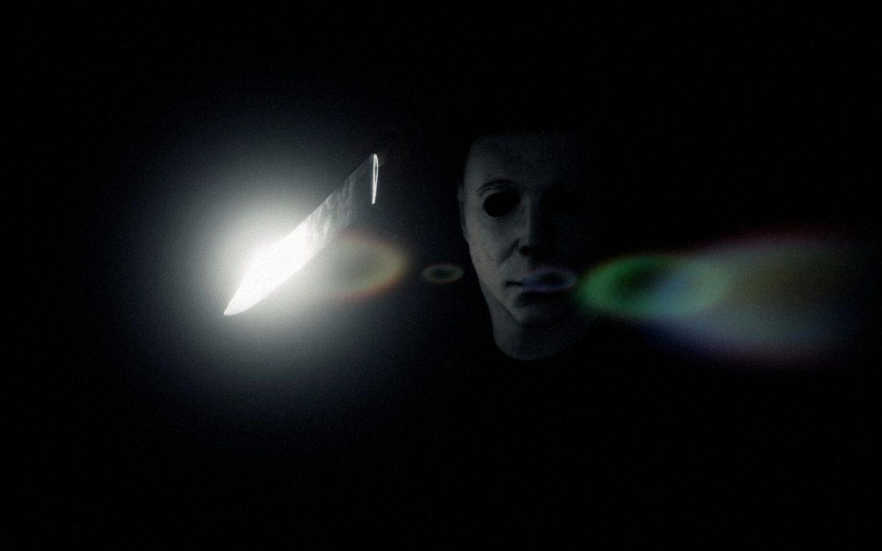 Le masque de Michael Myers émerge du noir, une lame scintille à côté