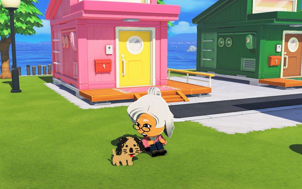 Un Mii âgé caresse son chien devant une maison rose