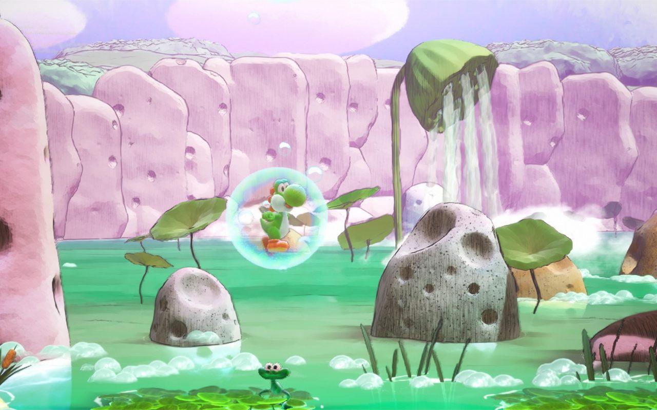 Yoshi dans une bulle sur un lac vert bordé de falaises roses et d'une cascade