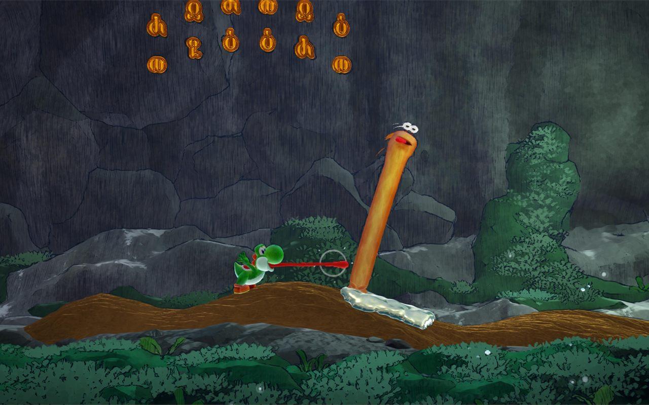 Yoshi attrape avec sa langue une longue créature orange dans une grotte